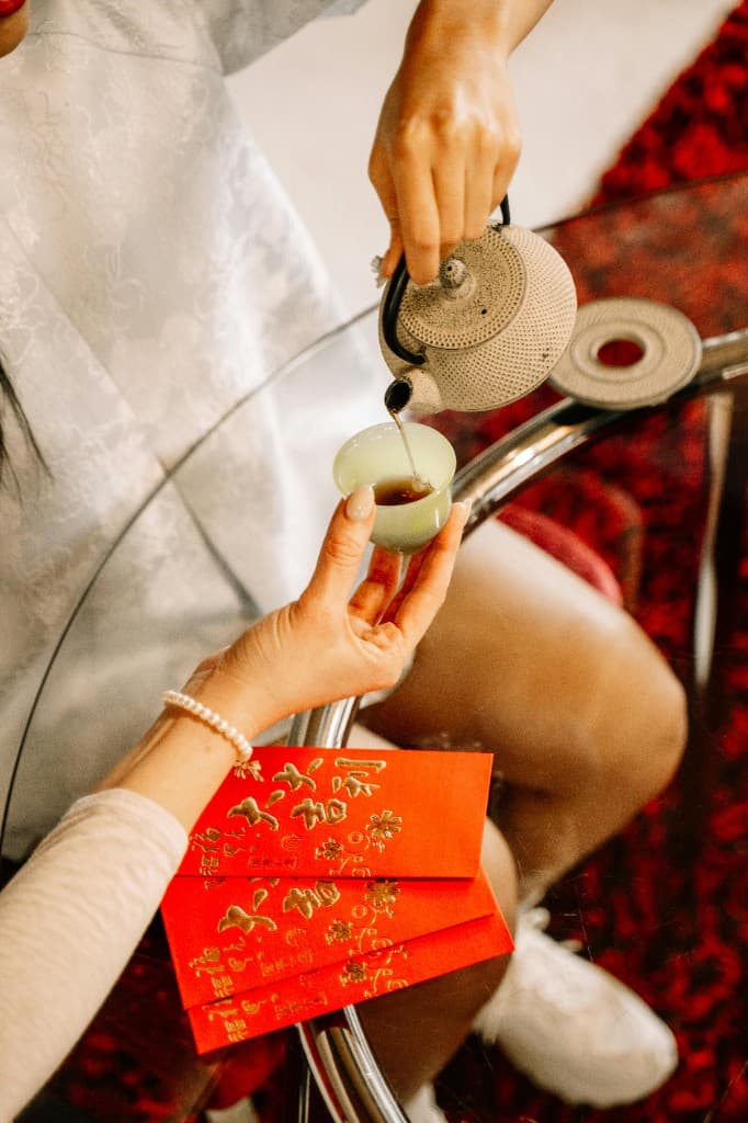 Pouring tea from a traditional teapot